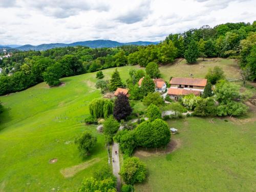 an aerial view of a house on a green field at Hirschenhof in Graz
