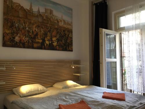 Schlafzimmer mit einem Bett mit Wandgemälde in der Unterkunft Coronation Apartment in Bratislava