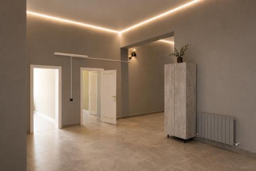 an empty room with a hallway with two doors at Nomad Aktau Hostel in Aktau