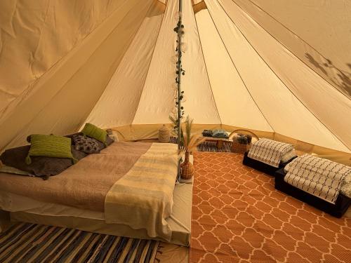 a bedroom with a bed in a tent at Lahemaa Nature Glamping - Kuma in Vihasoo