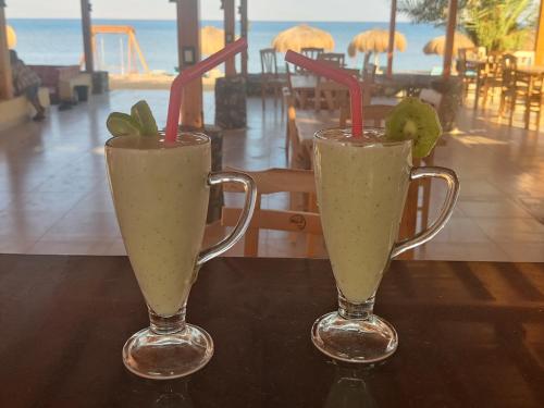 two drinks in mugs sitting on top of a table at Mermaid camp in Nuweiba