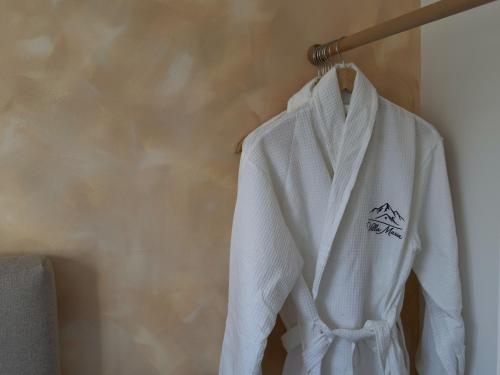 a white robe hanging on a wall at Villa Maria in Ribarica