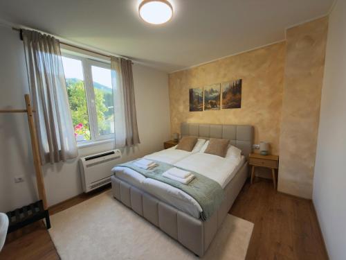 a bedroom with a large bed and a window at Villa Maria in Ribarica