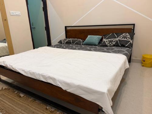 a bed with white sheets and pillows on it at Drip Home Stay AKTU in Lucknow