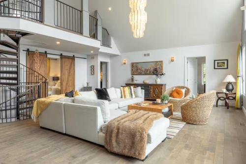 a living room with a white couch and chairs at 5-Br Villa on Lake Labelle Chalet Jacob in Labelle