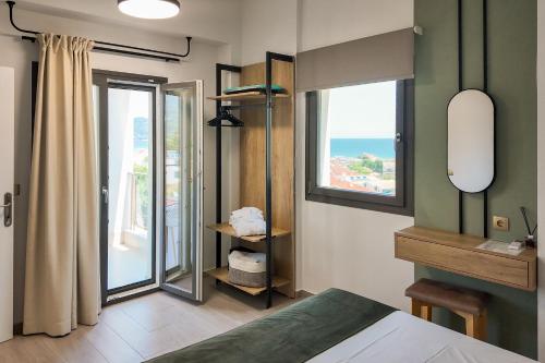 a bedroom with a bed with a view of the ocean at Green Hill Thassos in Skala Potamias