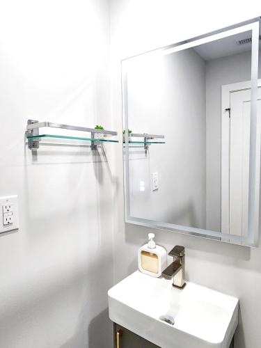 a bathroom with a sink and a large mirror at Luxury Nest B&B in Niagara-on-the-Lake