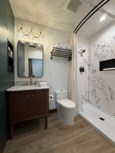 a bathroom with a sink toilet and a mirror at Historic Tomahawk in Green River