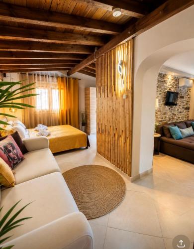 a living room with a couch and a bed at Sea La Vie in Keramídhion