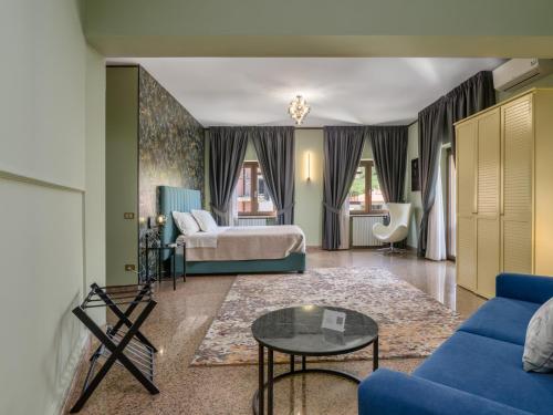 a living room with a bed and a couch at Villa Francesca Luxury Rooms in San Demetrio Corone