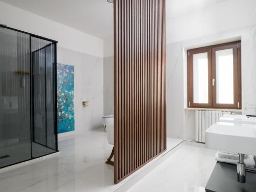 a bathroom with a shower and a sink and a toilet at Villa Francesca Luxury Rooms in San Demetrio Corone
