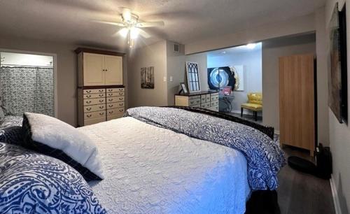 a bedroom with a bed with a blue and white blanket at Cozy Hideaway guest suite in Midlothian