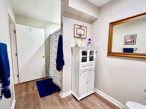 a bathroom with a mirror and a white cabinet at Cozy Hideaway guest suite in Midlothian