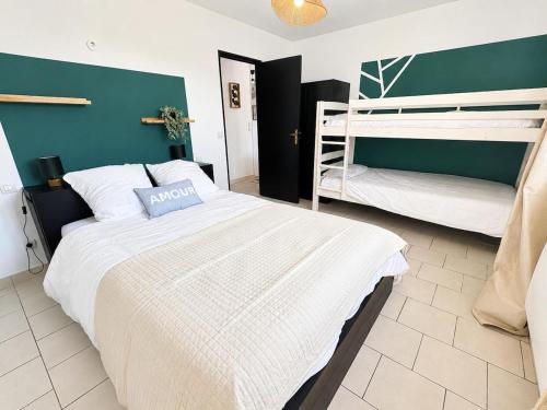 a bedroom with two bunk beds in a room at Maison avec jardin in Harquency