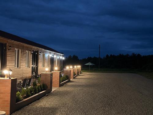 a row of lights on the side of a building at night at Tornikes Cottages in Ureki