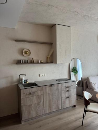a kitchen with a sink and a chair in a room at Locusdo apartment Nr 27 in Vilnius