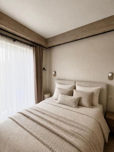 a bedroom with a large white bed with a window at Locusdo apartment Nr 27 in Vilnius