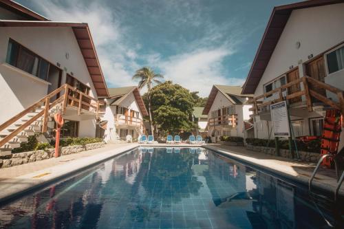 a swimming pool in front of two buildings at Decameron San Luis - All Inclusive in San Andrés