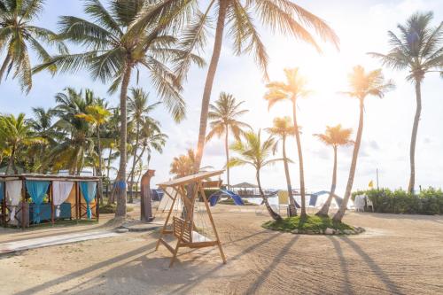 a playground on a beach with palm trees at Decameron Marazul - All Inclusive in San Andrés