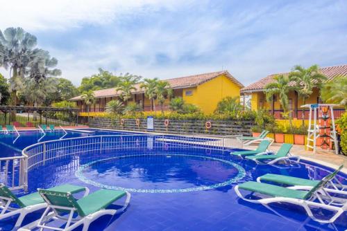 a swimming pool with lounge chairs and a resort at Decameron Panaca - All Inclusive in Quimbaya
