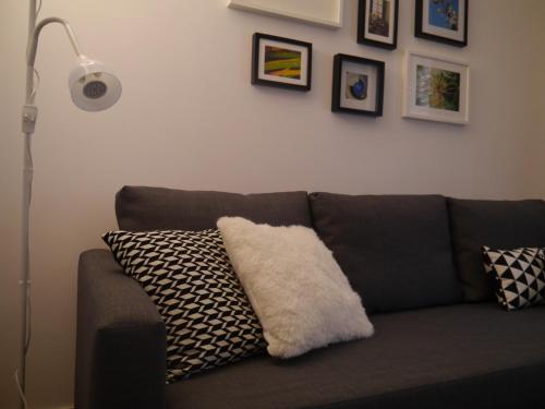 a couch with a white pillow on it in a living room at Apartamento Boavista in Vila Nova de Gaia