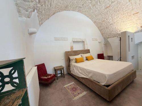 a bedroom with a bed in a white room at Casa Maresca in Ostuni