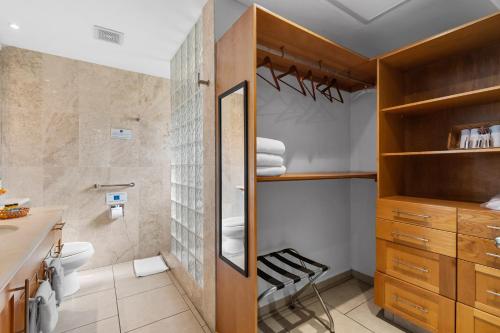 a bathroom with a toilet and a sink at Marina Banderas Suites Hotel Boutique in Nuevo Vallarta