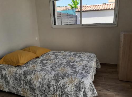 a bedroom with a bed and a window with a view at chez Virginie et Jacky in Les Épesses
