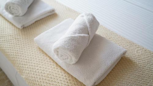 two towels sitting on top of a bed at Apartmani Vela Luka in Vela Luka