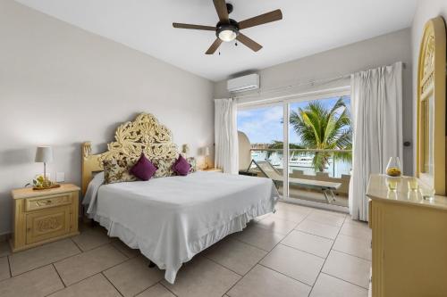 a bedroom with a bed and a large window at Marina Banderas Suites Hotel Boutique in Nuevo Vallarta