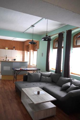 a living room with a couch and a table at Moderne offene Wohnung in Bad Sulza