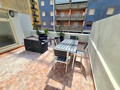 a patio with a table and chairs on a balcony at Civico 8 Apartment in Sassari