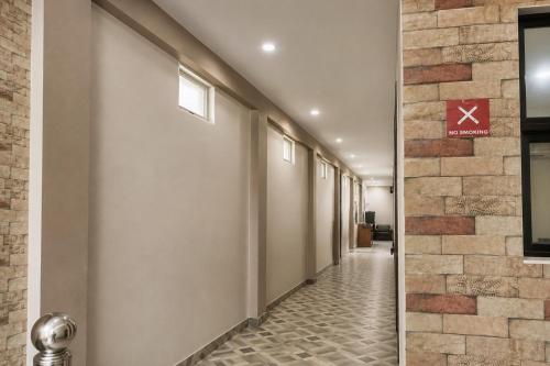 a corridor of a hallway with a tile floor at Hotel Galaxia Inn Near PEC College in Chandīgarh