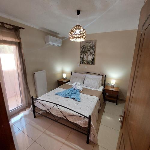 a bedroom with a bed with a blue robe on it at The Mastiha Spot 3 in Chios