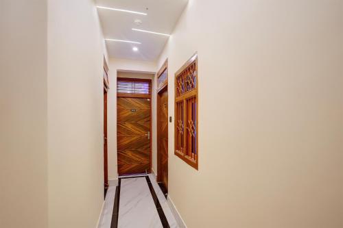 a hallway with wooden doors in a house at Hotel O SINGH GRAND HOTEL& BANQUET in Gorakhpur