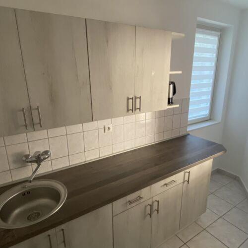 a bathroom counter with a sink and a window at Greenhouse Apartman in Zalakaros