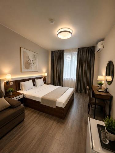 a hotel room with a bed and a couch at Golden Fleece Hotel in Ureki