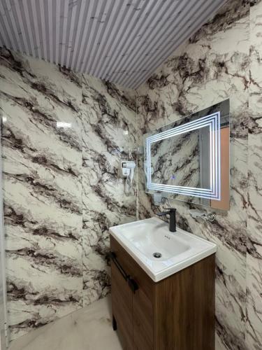 a bathroom with a sink and a mirror at Sidi's GuestHouse in Borsh