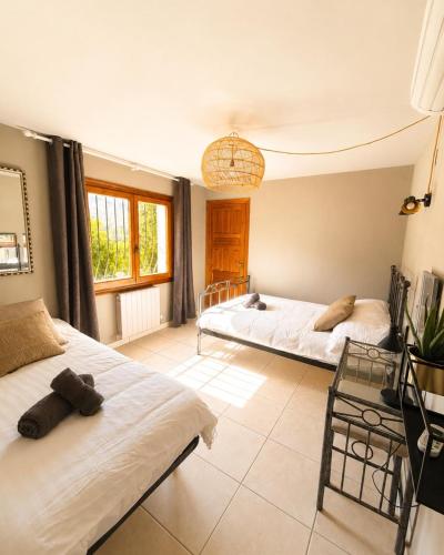 a bedroom with two beds and a window at Casa Toucan Moraira in Benitachell
