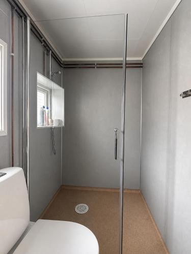 a bathroom with a shower and a toilet at Turifoss Camping Tent pitch in Svedjan