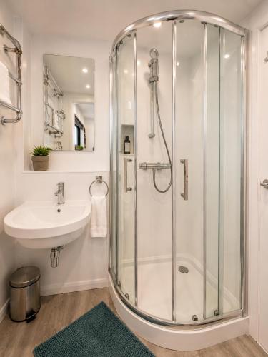 a bathroom with a shower and a sink at Historic Dutch Barge, Idyllic location in London
