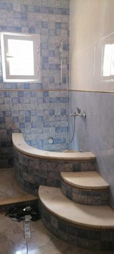 a bathroom with two toilets and a bath tub at Maison Souad Guest House in Chott Meriem