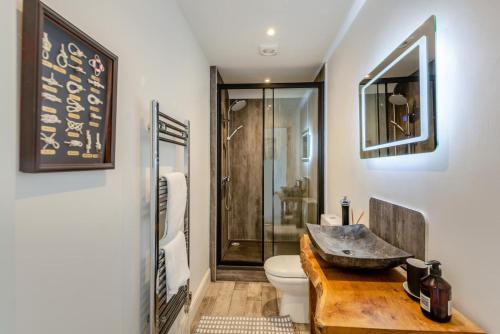 a bathroom with a sink and a toilet and a shower at 3 Bed in Bideford oc-79552 in Bideford