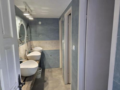 a bathroom with two sinks and two toilets at Kamp Kalavat in Vrtovac