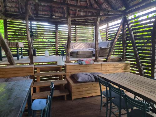 a room with a bed and tables and chairs at Kamp Kalavat in Vrtovac