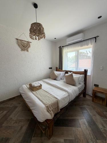 a bedroom with a large bed with a chandelier at City Retreat Arusha in Arusha