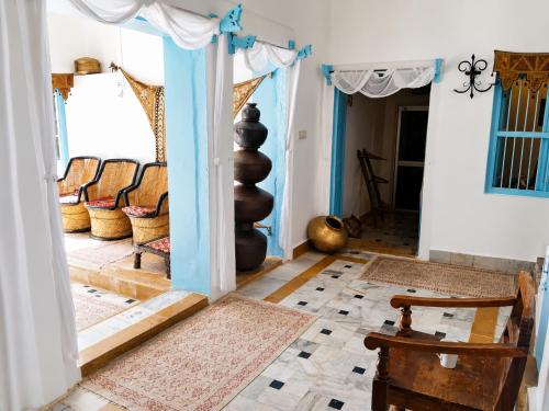 a living room with a doorway with chairs and a floor at Killa Bhawan Lodge in Jaisalmer
