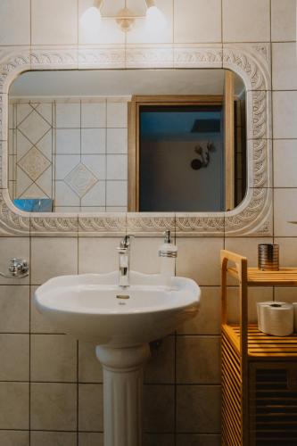 a bathroom with a white sink and a mirror at Platanos View in Plátanos