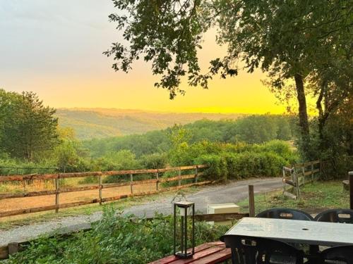 a picnic table with a view of the mountains at N6 Emplacement tente van camping-car in Saint-Aubin-de-Nabirat