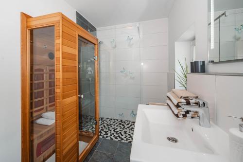a bathroom with a sink and a shower at Haus Auszeit in Rauris